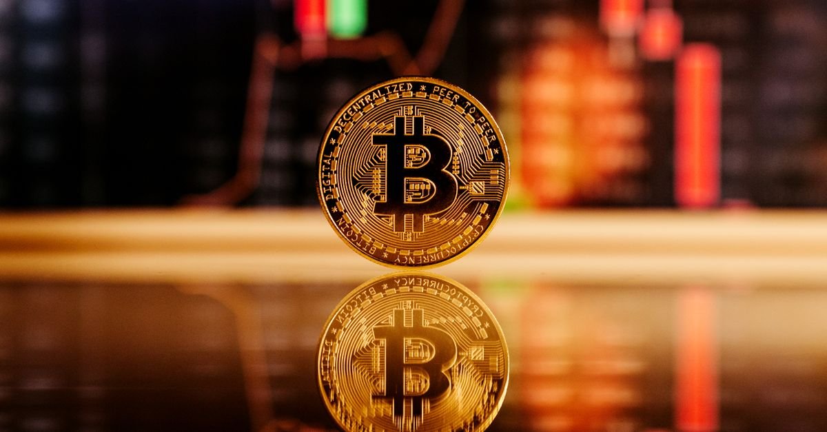 Close-up of a Bitcoin coin with stock market chart background