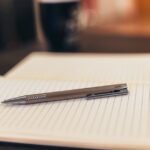 Notebook and pen representing writing down and backing up a crypto seed phrase