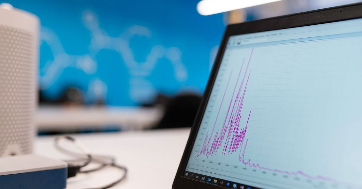 Laptop displaying a data analytics graph representing crypto portfolio tracking