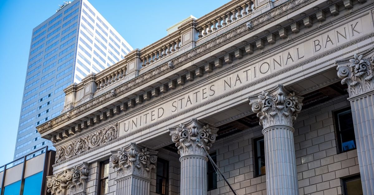Facade of a traditional bank building with columns representing traditional banking