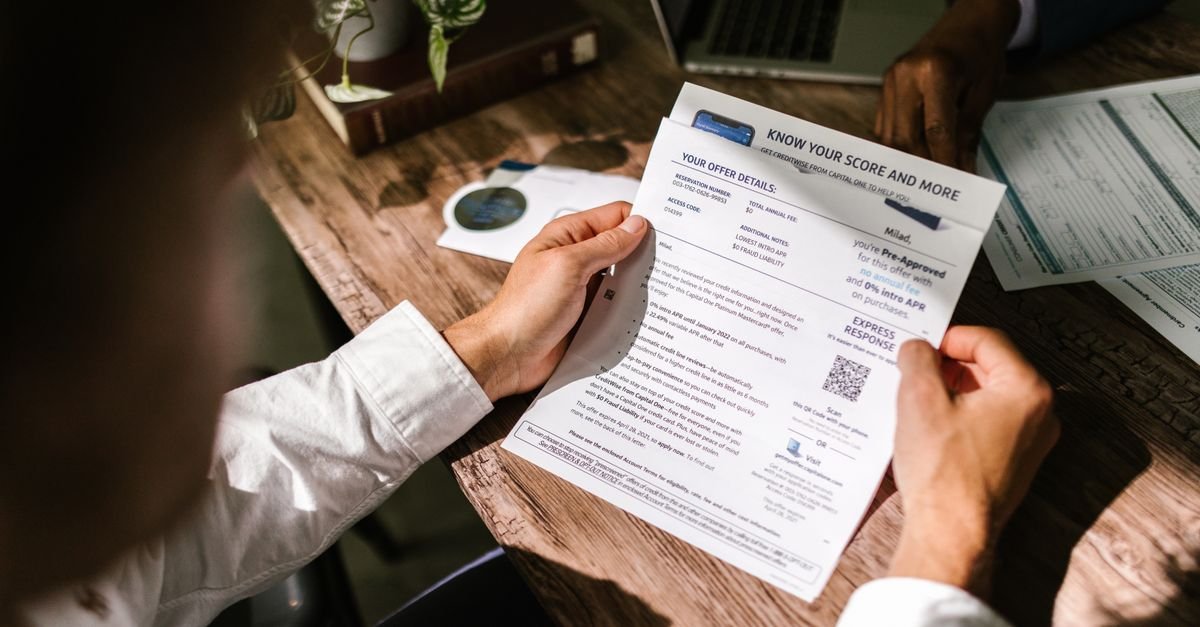 Person reading a document at a desk representing reading a crypto whitepaper